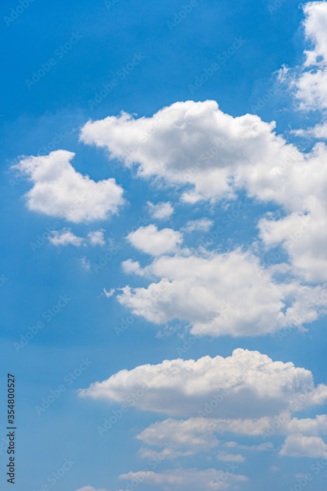 Vertical photo of cumulus white cloud on bright blue sky Vertical photo of cumulus white cloud on bright blue sky