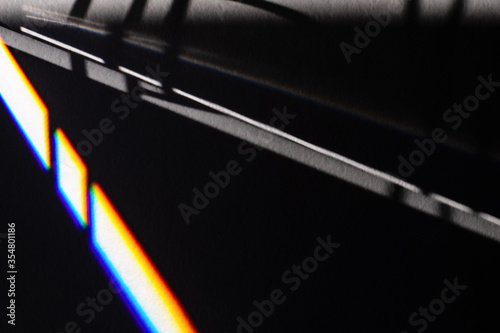Black futuristic shadows and bright light refraction glow effect with colorful rainbow. Black noir future tech stylish background. Modern dark abstract art backdrop. design template for any purposes.