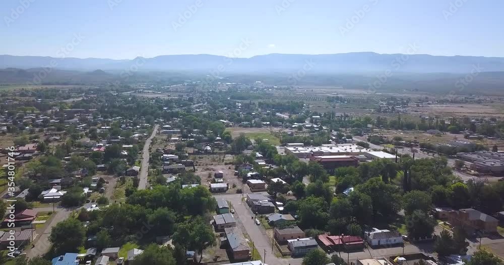 Drone flyover of small New Mexico town on a bright summer day. Drone flyover of small New Mexico town on a bright summer day.
