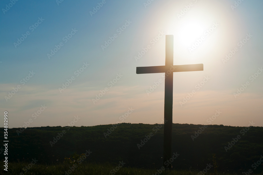 Wooden cross against the sky and sunrise. Death of jesus