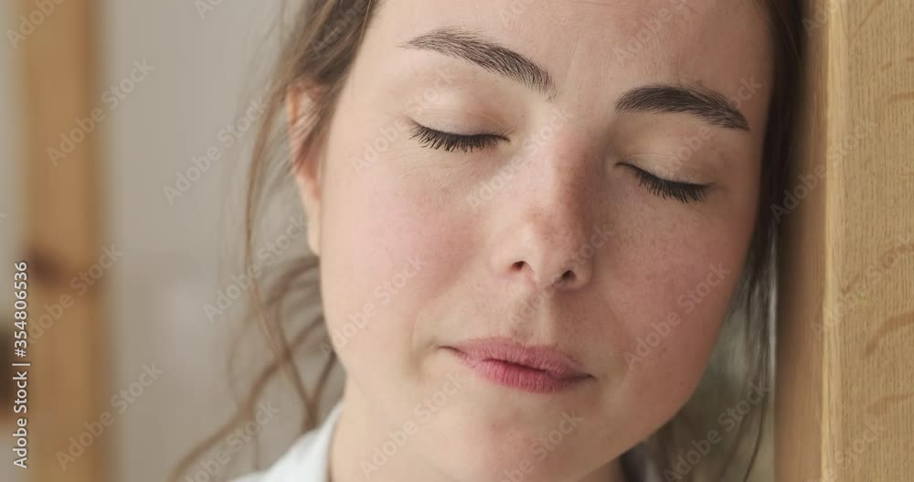 Portrait of worried woman taking a deep breath and smiling