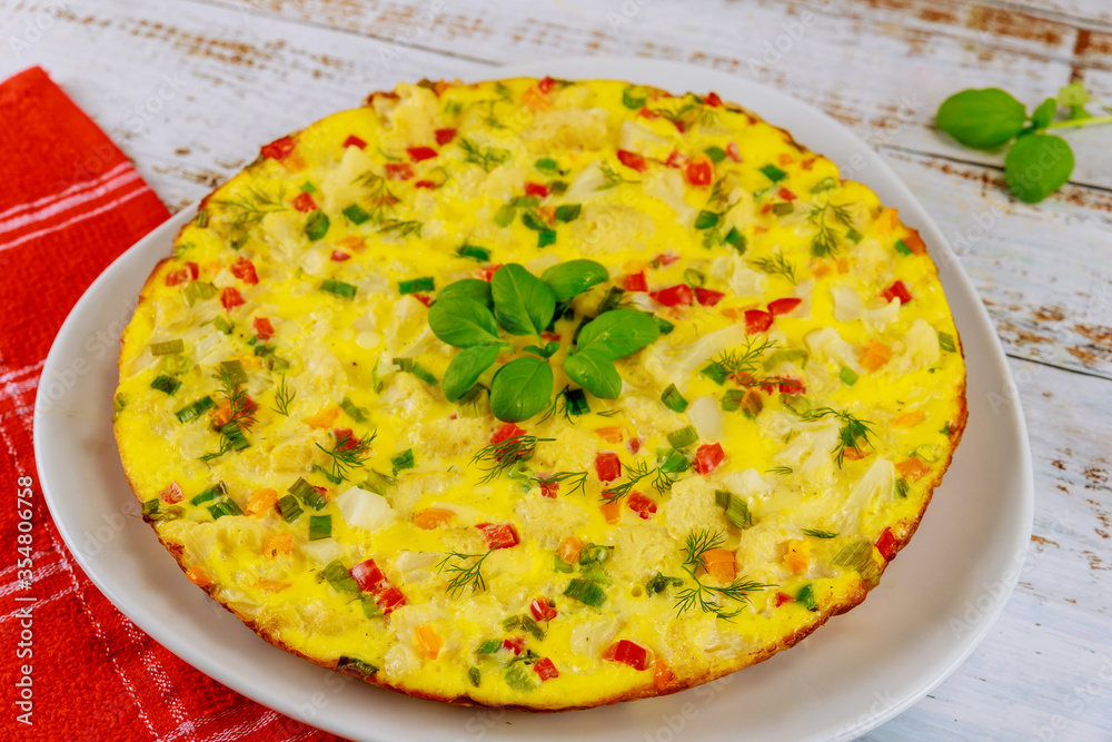 Homemade omelette with vegetables on white plate. Homemade omelette with vegetables on white plate.