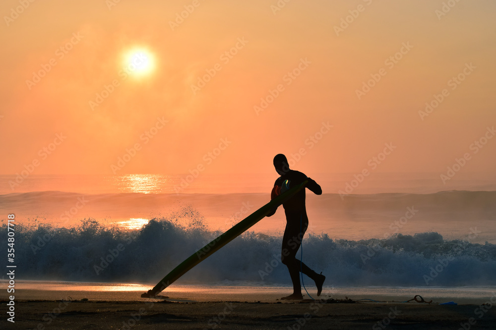 Silhoette Surfer on a misty beach in Chiba Japan with a stunning sunrise and waves. Lifestyle,surfboard,surfing,Japansurf