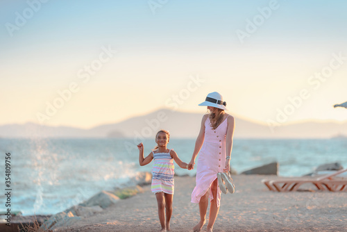 Young mother with her daughter walking at the promenade alley