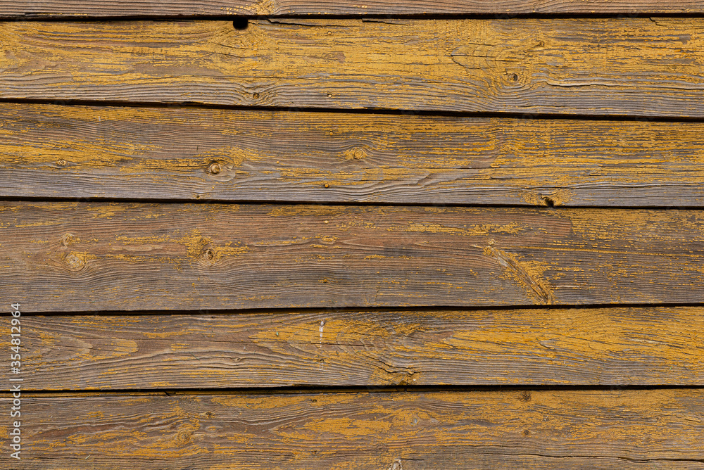 Texture of a yellow fence made of wooden boards