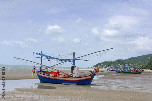 The fishing boat is parked by the blue sea at Hua Hin ,Thailand. Good for postcard or background.