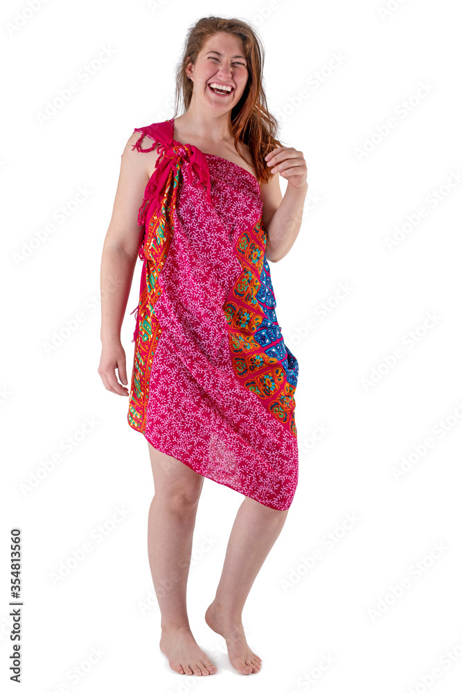 Young woman in red dress stands barefoot against white background Young woman in red dress stands barefoot against white background