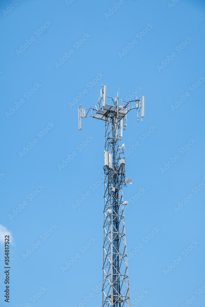 Cellular Base Station or Base Transceiver Station. Telecommunication tower. Wireless Communication Antenna Transmitter. 3G, 4G and 5G Cell Site with blue and cloudy sky. Cellular Base Station or Base Transceiver Station. Telecommunication tower. Wireless Communication Antenna Transmitter. 3G, 4G and 5G Cell Site with blue and cloudy sky.