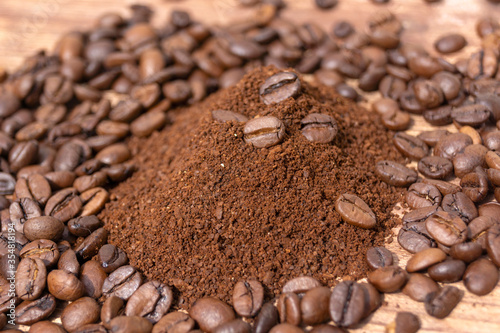 ground coffee on the background of loose coffee beans