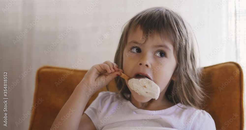 Adorable little girl licking ice cream Adorable little girl licking ice cream