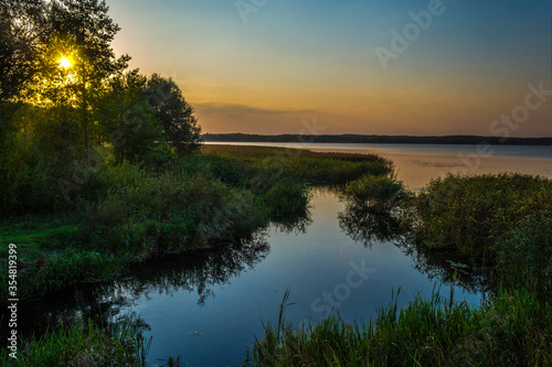 Fototapeta Naklejka Na Ścianę i Meble -  Spring landscape in the evening on the lake shore