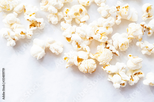 Tasty salted popcorn close-up on white background. Top view minimalistic popcorn
