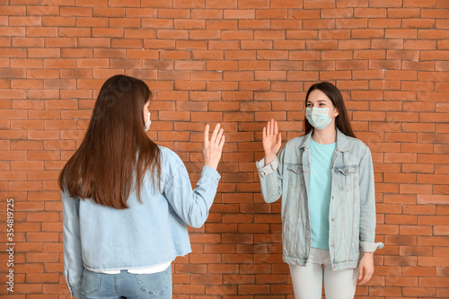 Young women greeting each o...