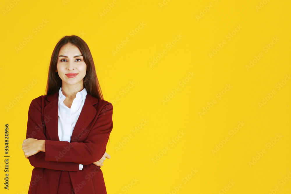 Business Caucasian woman in red suit smiling and smart isolated on yellow background. Business Caucasian woman in red suit smiling and smart isolated on yellow background.