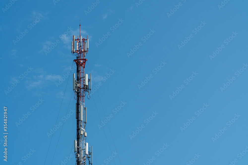 Cellphone or Mobile phone 3g, 4g and 5g transmitter tower with antenna on the clear blue sky background with copy space for text, today wide area technology concept.