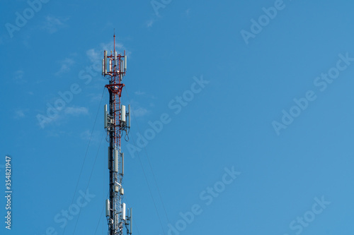 Cellphone or Mobile phone 3g, 4g and 5g transmitter tower with antenna on the clear blue sky background with copy space for text, today wide area technology concept.