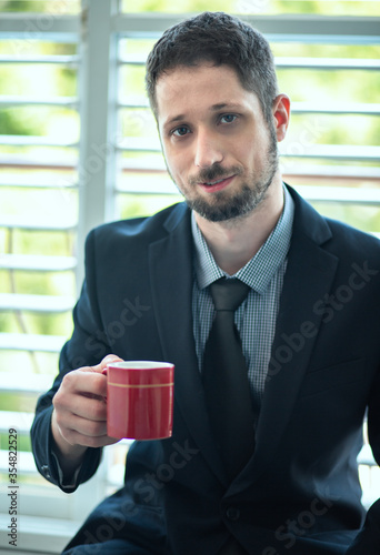 Businessman drinking coffee at the office.