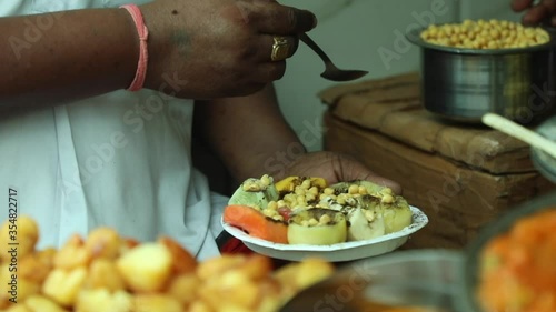 Preparation of Indian style fruit salad, fruit chaat in Chandni Chowk, Old Delhi, India at Hiralal Chaat.