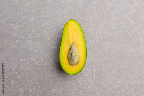 Half of avocado isolated on gray background. Copy space banner.
