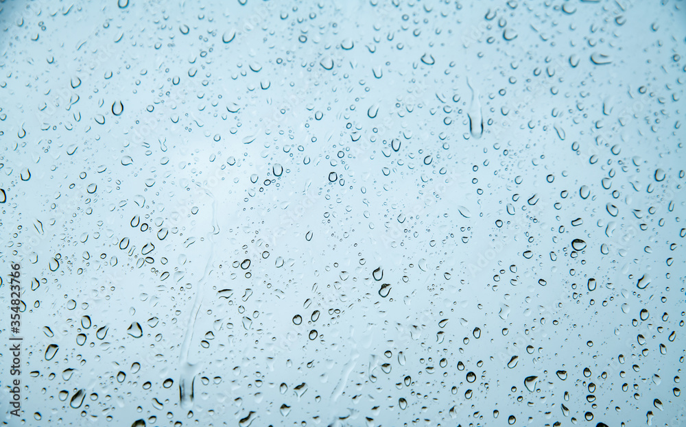 drops of water on glass with a blue tint