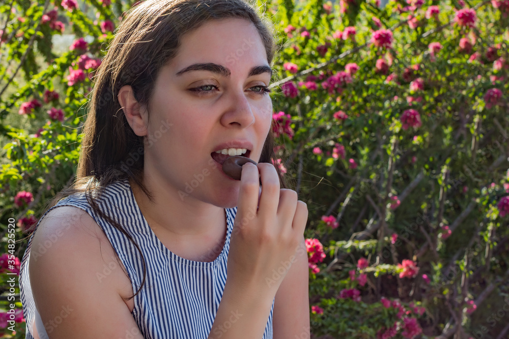 girl eating a chocolate snack bar.