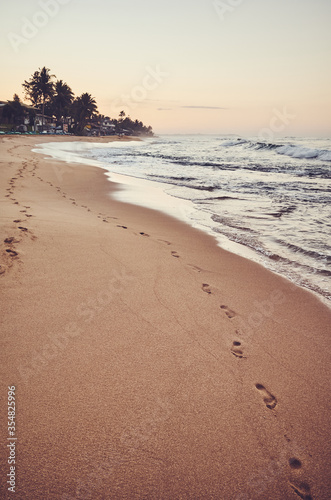 Empty tropical beach at sunrise, color toning applied, Sri Lanka.