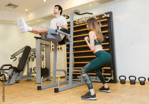 Attractive young couple working out in hotel gym