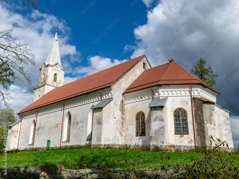 landscape with white church on the hill, beautiful blue sky with white cumulus clouds, Trikata church, Latvia landscape with white church on the hill, beautiful blue sky with white cumulus clouds, Trikata church, Latvia