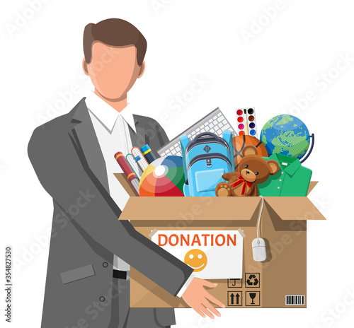 Man, cardboard donation box toys, books, clothes and devices. Help for children, support for poor kid. Donate container in hand. Social care, volunteering, charity concept. Flat vector illustration