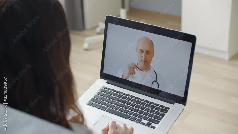 Doctor at screen. Woman using laptop and talking online with general practitioner. Professional doctor explaining diagnosis and talking about disease on laptop computer screen. Telemedicine concept Doctor at screen. Woman using laptop and talking online with general practitioner. Professional doctor explaining diagnosis and talking about disease on laptop computer screen. Telemedicine concept