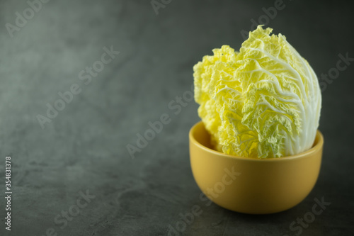 Heap fresh of green chopped iceberg lettuce in yellow bowl