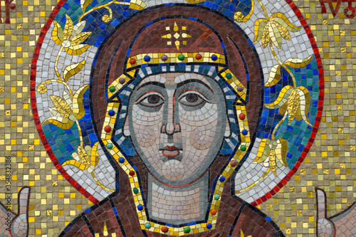 The Christian Virgin and Child Jesus in the form of ceramic mosaics on the facade of the Orthodox church. Traditional christian greek decor and fresco.