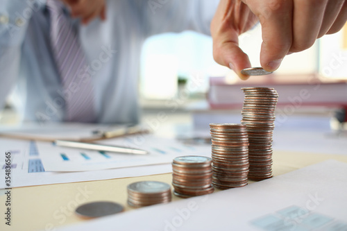 Hand businessman putting pin money