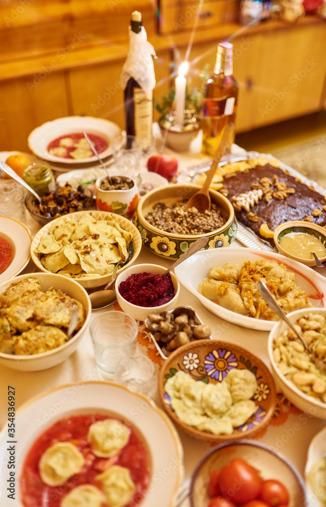 Traditional Ukrainian food. Kutya, borsch, dumplings, cabbage rolls on festive table.