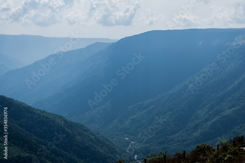 Natural view of the folded mountains and lush green valleys with clear sky and clouds of Cherrapunji, Meghalaya, North East India  © H K Singh