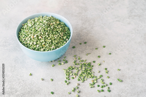 Beautiful healthy food background. Dry green peas in a bowl on a light background. Fiber intake serves as an important factor in weight loss by functioning as a “bulking agent” in the digestive system