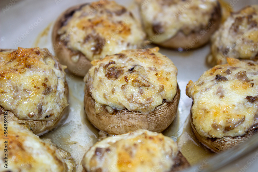 Stuffed mushrooms stuffed with cheese, mushroom stalks and onions. In a baking dish. Stuffed mushrooms stuffed with cheese, mushroom stalks and onions. In a baking dish.
