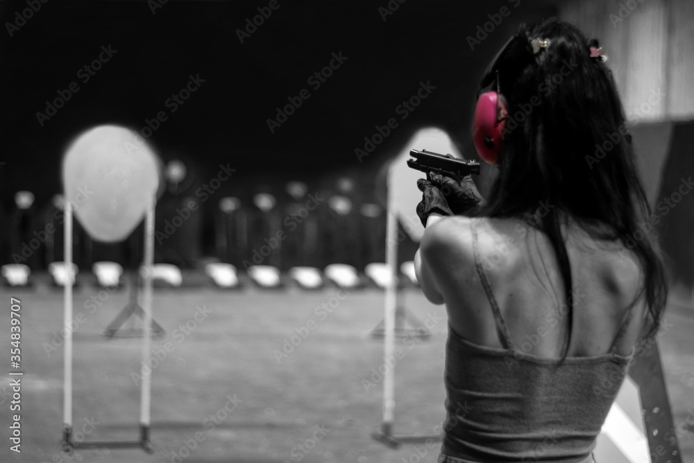 woman racticing in shooting gallery