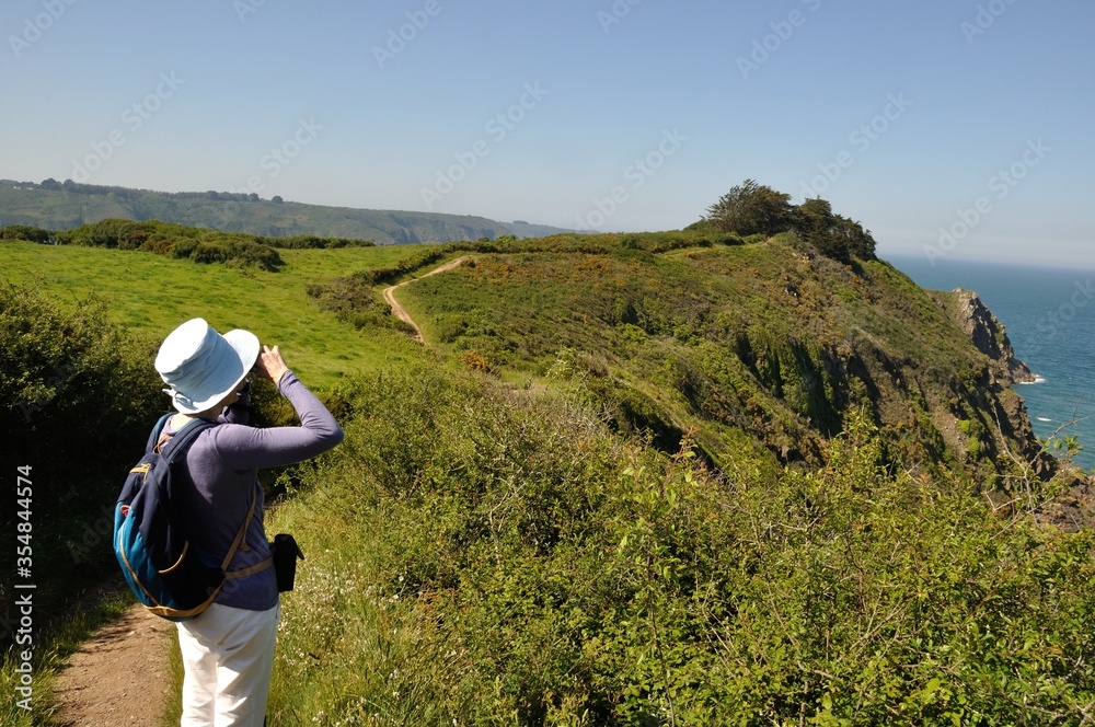 PLOUHA, FRANCE -May25 2017 : Hiker on the GR34 at Plouha PLOUHA, FRANCE -May25 2017 : Hiker on the GR34 at Plouha