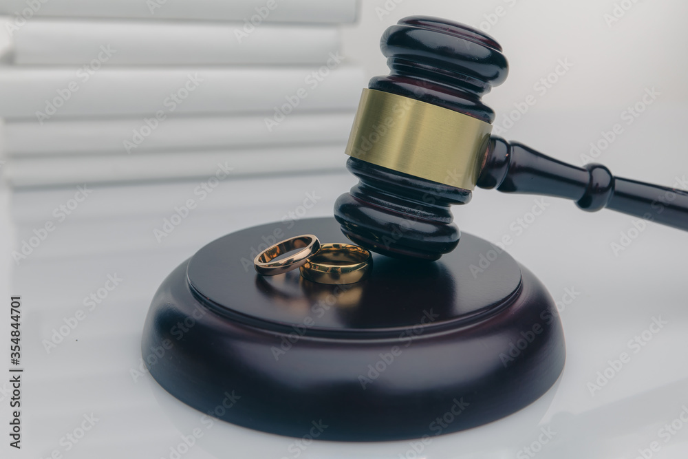 Couple with divorce contract and ring on desk. Divorce.