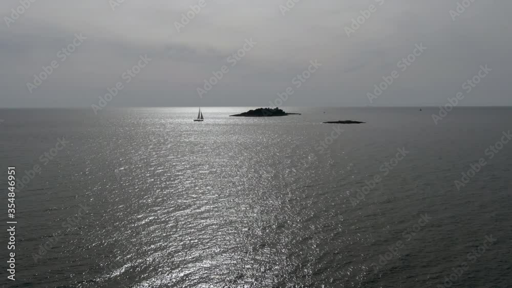 Drone shot of an empty island in the middle of a Adritic sea in Croatia with a single yacht. Drone shot of an empty island in the middle of a Adritic sea in Croatia with a single yacht.