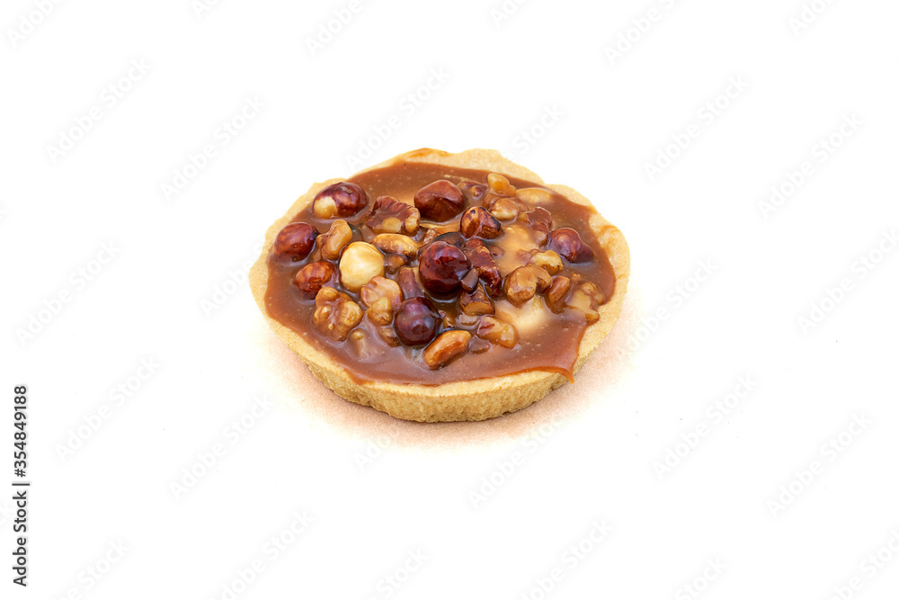 A round cake basket with condensed milk and nuts. Close-up on white background A round cake basket with condensed milk and nuts. Close-up on white background