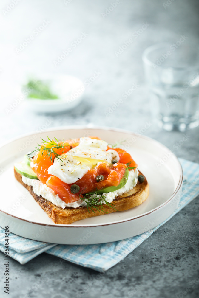 Poached egg with salmon and avocado on toast Poached egg with salmon and avocado on toast