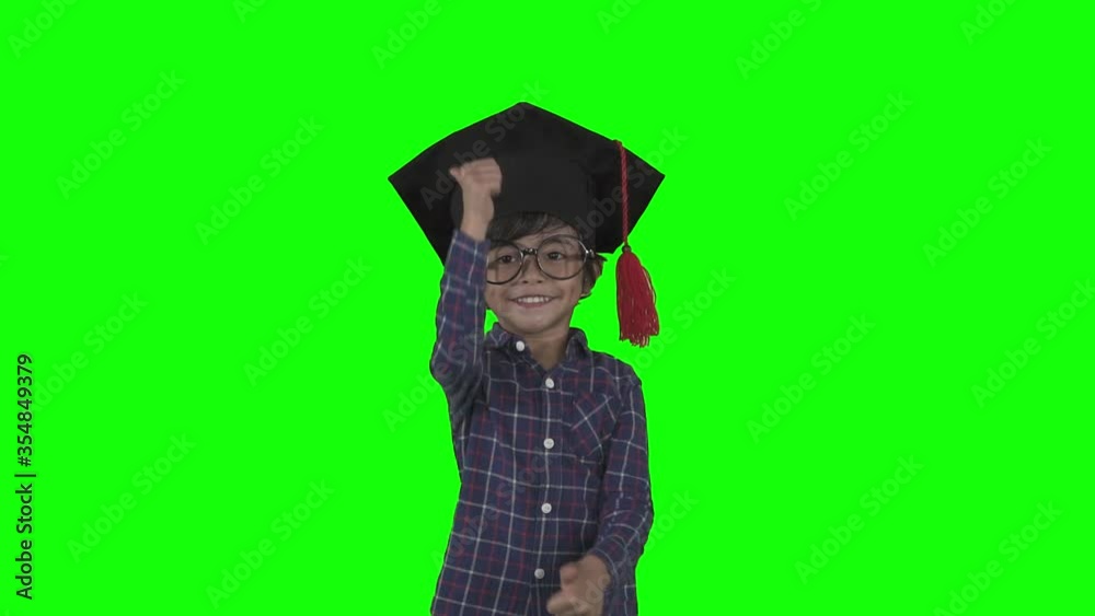 Little boy wears graduation hat and show thumbs up Little boy wears graduation hat and show thumbs up