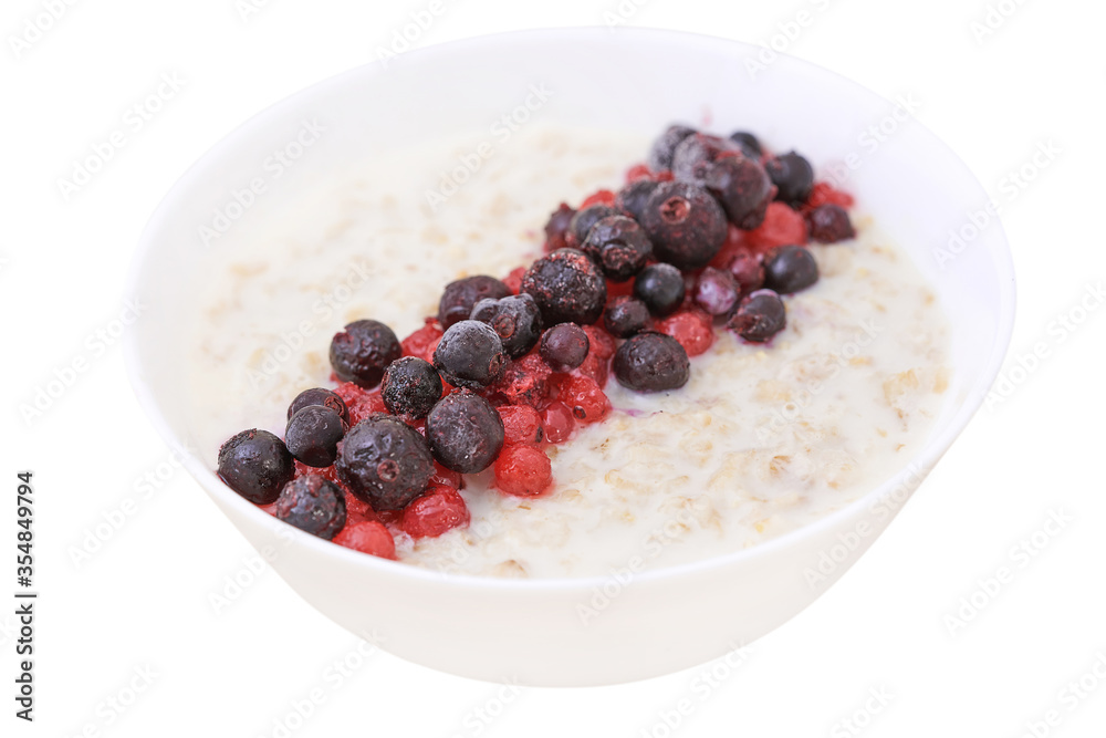 Oatmeal in a white bowl of blueberries and red currants. Healthy Breakfast Oatmeal in a white bowl of blueberries and red currants. Healthy Breakfast