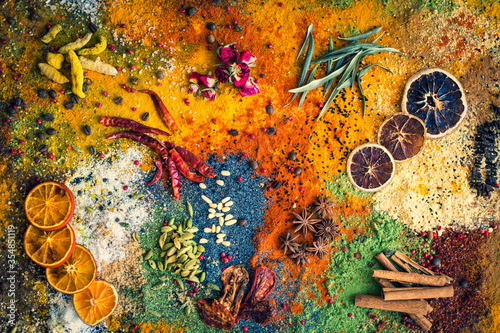 Fototapeta Naklejka Na Ścianę i Meble -  Many multi colored spices and dried fruits on the table