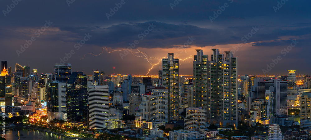 Night City scape of Bangkok central with Lightning and cloudy background Night City scape of Bangkok central with Lightning and cloudy background