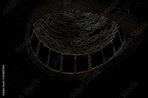 A dark abstract view of a canal tunnel air shaft in Netherton canal tunnel in Dudley UK photo