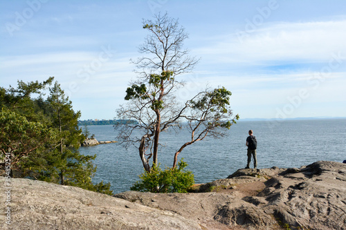 Man walking on the rocky coast. Hiking in Canada.