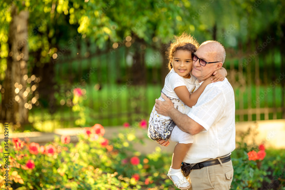 Little granddaughter hugging her grandfather Little granddaughter hugging her grandfather